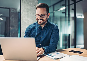 Man filling out a form on his laptop