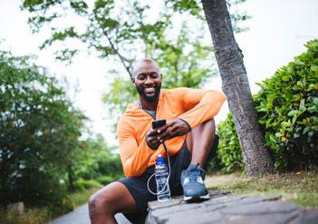 Man looking at his phone in a park