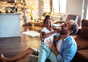 Father and daughter on the floor laughing